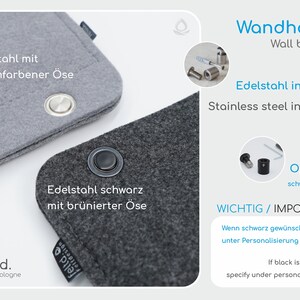 K&ouml;nnte beinhalten: Nahaufnahme von zwei Wandhaltern aus Filz, einer grau mit silberner &Ouml;se und der andere dunkelgrau mit schwarzer &Ouml;se. Text auf dem Bild: "Wandhalter" und "Edelstahl inklusive."
