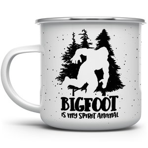 May include: White enamel camping mug with a black silhouette of Bigfoot walking through a forest. The text "BIGFOOT IS MY SPIRIT ANIMAL" is printed below the image.