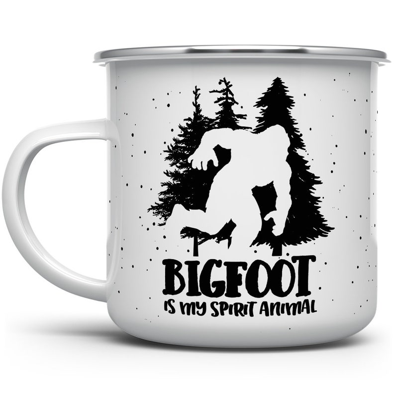 May include: White enamel camping mug with a black silhouette of Bigfoot walking through a forest. The text "BIGFOOT IS MY SPIRIT ANIMAL" is printed below the image.