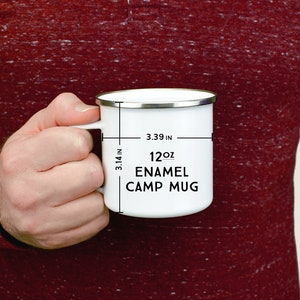 May include: White enamel camp mug with a black inscription that reads "12oz Enamel Camp Mug". The mug is 3.39 inches wide and 3.14 inches tall.