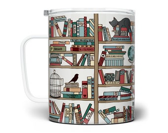May include: A white ceramic mug with a handle features a colorful illustration of a bookshelf filled with books. The books have titles like "To Kill a Mockingbird", "The Little Princess", and "The Cat in the Hat".