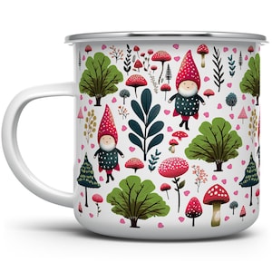 May include: White enamel mug with a whimsical design featuring gnomes, mushrooms, and hearts. The design is in shades of red, green, and pink.