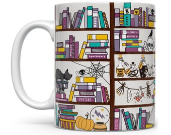 May include: White ceramic mug with a colorful illustration of a bookshelf filled with books, potions, and other magical items. The books have titles like "Magic Spells", "Potions", "Apothecary", and "Recipes". There is a black cat sleeping on top of a stack of books.