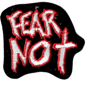 May include: A black embroidered patch with white and red stitching. The patch says "Fear Not" in a bold, stylized font.