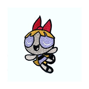 May include: Embroidered patch featuring a cartoon character with a red bow, yellow hair, and purple eyes. The character is wearing a black and yellow outfit. The patch is designed for application on clothing or accessories.