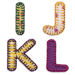 May include: Four fabric letters, I, J, K, and L, in different colors and patterns. The letters are sewn with a yellow thread and have a patchwork design.