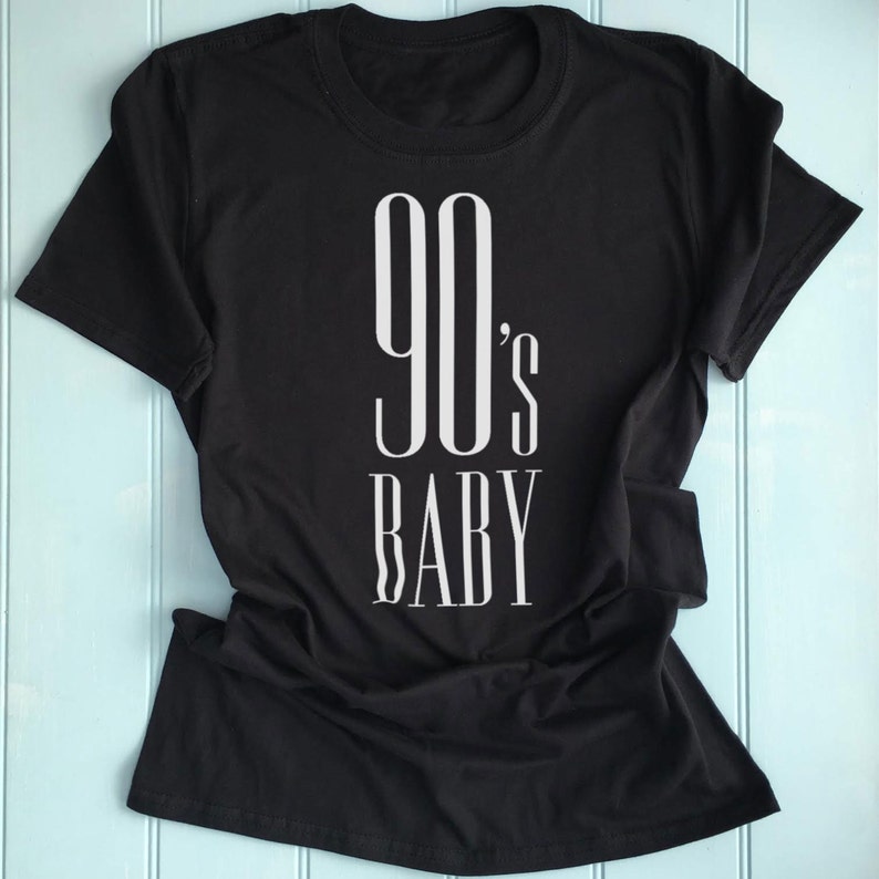 May include: Black t-shirt with white text that reads "90's Baby"