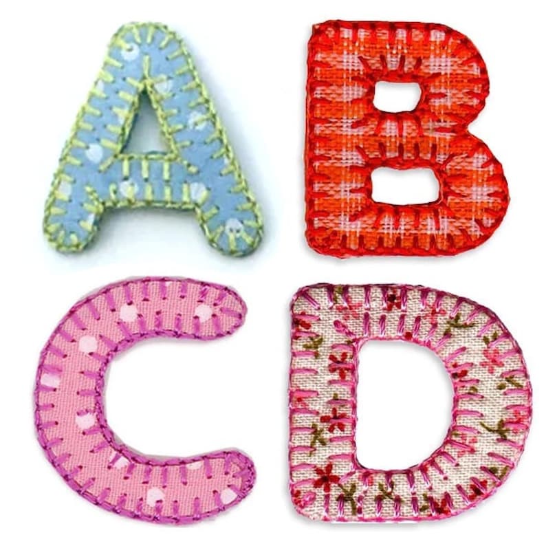 May include: Four fabric letters, A, B, C, and D, in different colors and patterns. The letters are sewn with a pink thread.