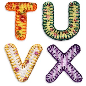 May include: Four fabric letters, T, U, V, and X, with a patchwork design. The letters are in yellow, green, white, and purple.