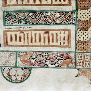 May include: A close-up of a page from an illuminated manuscript. The page features intricate Celtic knotwork in shades of green, brown, and red. The text "alpha hauncy rune" is written in black ink.