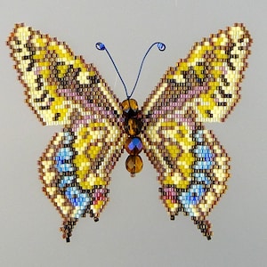 May include: A beaded butterfly brooch with yellow, brown, and blue accents. The butterfly has a detailed design and a crystal-like center.