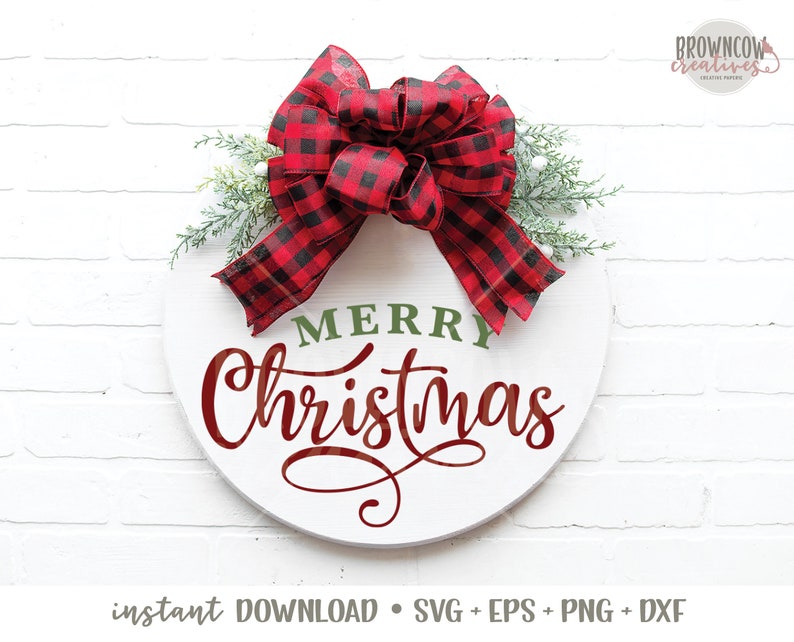 May include: A white round wooden sign with the words "Merry Christmas" in red cursive lettering and "Merry" in green lettering. A red and black buffalo plaid bow with green sprigs is attached to the top of the sign.