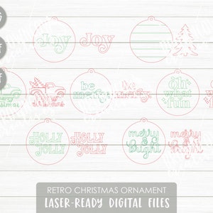 May include: A set of 10 laser-cut Christmas ornament designs featuring retro-style text and images. The designs include "joy", "be merry", "merry & bright", "holly jolly", "oh what fun", and a Christmas tree. The designs are in pink and green.