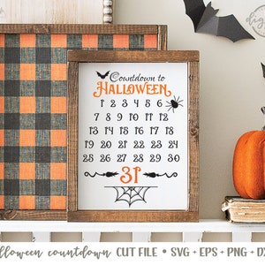 May include: A white sign with a black and orange Halloween countdown. The sign says "Countdown to HALLOWEEN" and has the numbers 1 through 31 listed. The sign is framed in wood and has a black and orange buffalo plaid background.