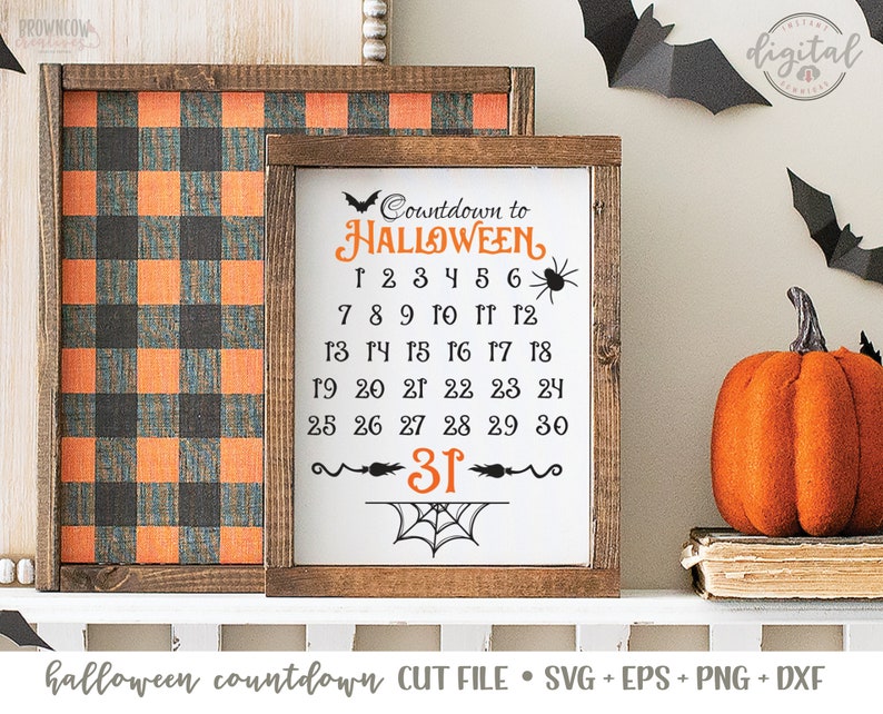 May include: A white sign with a black and orange Halloween countdown. The sign says "Countdown to HALLOWEEN" and has the numbers 1 through 31 listed. The sign is framed in wood and has a black and orange buffalo plaid background.