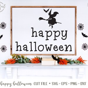 May include: A white sign with the text "happy halloween" in black lettering. A black silhouette of a witch flying on a broomstick with bats is above the text. The sign is on a white wall with black spiderwebs and bats.
