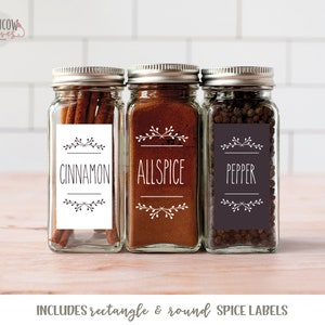 May include: Three glass spice jars with labels that say "Cinnamon", "Allspice", and "Pepper". The labels have a simple floral design and black text. The jars are filled with spices.