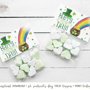 May include: Printable St. Patrick's Day treat topper with a rainbow, pot of gold, and shamrocks. The text reads "Happy St. Patrick's Day!"