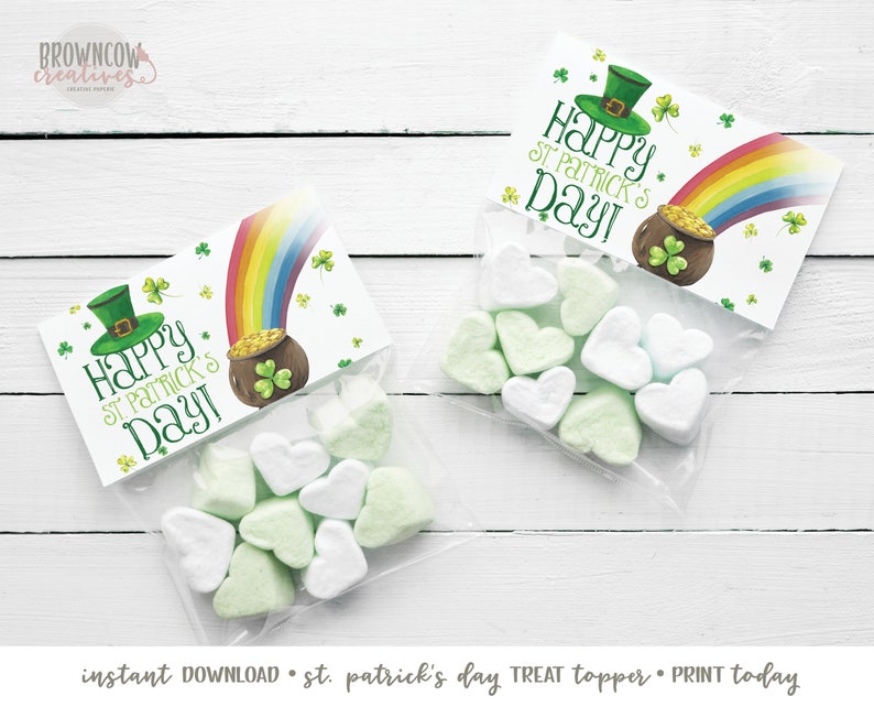 May include: Two printable treat bag toppers with a St. Patrick's Day theme. The toppers feature a green leprechaun hat, a pot of gold at the end of a rainbow, and the text 'Happy St. Patrick's Day!' The toppers are printed on white paper and are ready to be cut out and attached to treat bags.