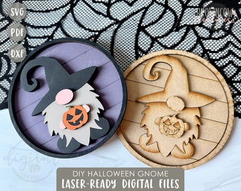 May include: Two round wooden signs with a Halloween gnome design. The gnome is wearing a black hat and holding a pumpkin. One sign has a purple background and the other has a wood grain background. The text "DIY HALLOWEEN GNOME LASER-READY DIGITAL FILES" is below the signs.