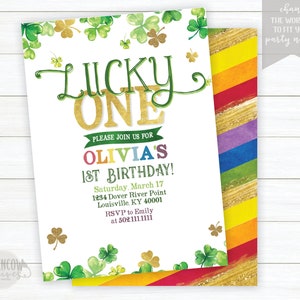 May include: A white invitation with green shamrocks and gold glitter. The text reads "Lucky One" in gold glitter letters. The invitation is for Olivia's 1st birthday party. The party is on Saturday, March 17th at 1234 Dover River Point, Louisville, KY 40001. RSVP to Emily at 502.111.1111.