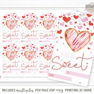May include: Printable Valentine's Day gift tags featuring a watercolor illustration of a heart-shaped cookie with pink frosting and red sprinkles. The tags have the text "You're Sweet" with spaces for "From" and "To".