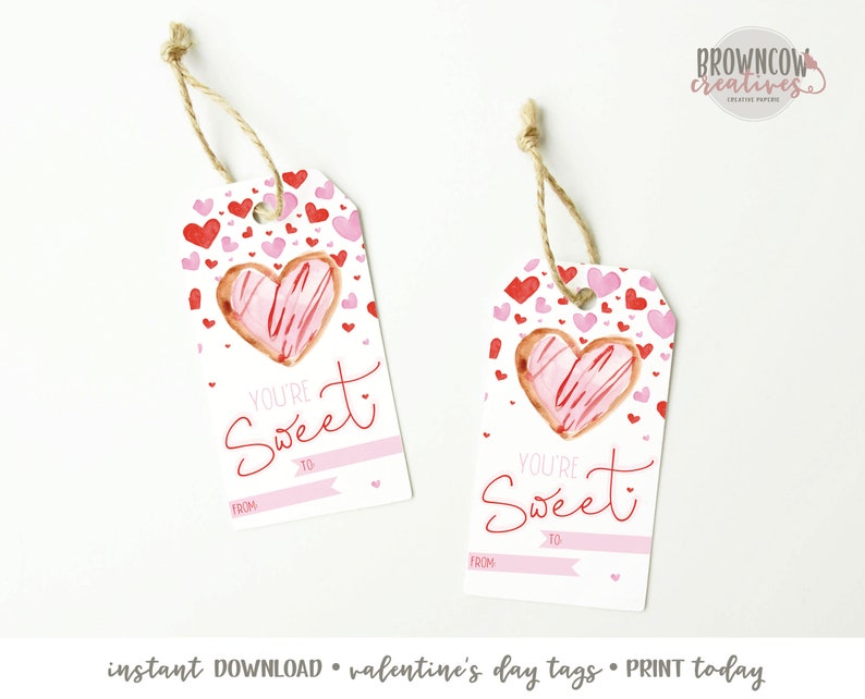 May include: Printable Valentine's Day gift tags featuring a pink heart-shaped cookie with red and pink sprinkles. The tags have the text "You're Sweet" and spaces to write "To" and "From".