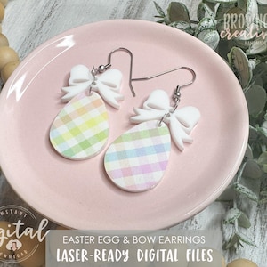 May include: A pair of pastel plaid Easter egg earrings with white bows. The earrings are on a pink plate and are laser-ready digital files.