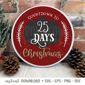 May include: A red and white round sign with the text "Countdown to 25 Days Christmas" in black and green lettering. The sign is decorated with white sprigs.