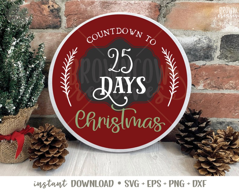 May include: A red and white round sign with the text "Countdown to 25 Days Christmas" in black and green lettering. The sign is decorated with white sprigs.