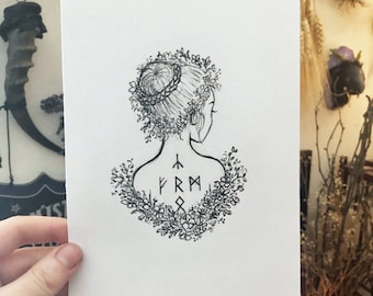 May include: A black and white illustration of a woman's back, adorned with a floral wreath and runes. The drawing style is simple, with delicate lines. The artist's signature, "ReeRee", is visible at the bottom right. The image is held by a hand.
