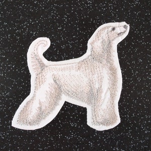 May include: A white embroidered patch of an Afghan Hound dog with a curled tail, standing on a black background.