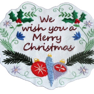 May include: Embroidered Christmas patch with a white background and green, red, blue, and purple embroidery. The patch features a wreath of holly, pine branches, and flowers with the text "We wish you a Merry Christmas".