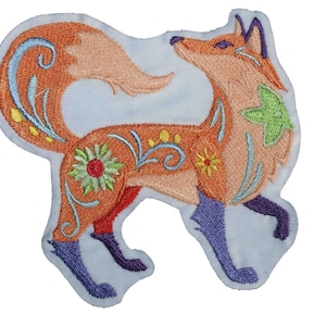 May include: An embroidered patch of an orange fox with blue legs and a floral design. The fox is standing on all fours and has its head turned to the side.