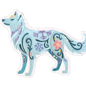 May include: A blue embroidered wolf with floral and snowflake designs. The wolf is standing on all four legs with its tail curled up.