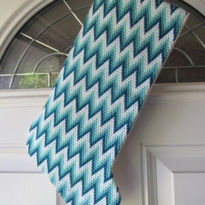Christmas stocking needlepoint traditional bargello pattern done in teals and white The length is 15 12 and the width at top is 6 12.