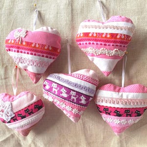 Christmas ornaments, done in crazy quilt sewing with different prints, hand embroidery, glass beads, sequins, hangers, polyester filled.