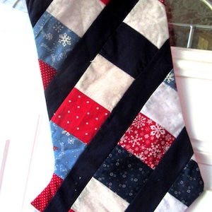Christmas stocking, red, white, blues, cotton fabric, red back and hanger, cotton lining, length 14 1/2 inches, width at top 6 3/4 inches.