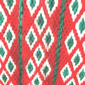 Needlepoint stocking done in bargello using white red and a green metallic yarn to work pattern, lined, red back and hanger