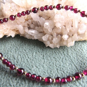 Bracelet gemstone garnet with 3 and 4mm garnets, 12k goldfilled beads and clasps.  In stock 7 inch, 7 1/2 inch and 8 inch,