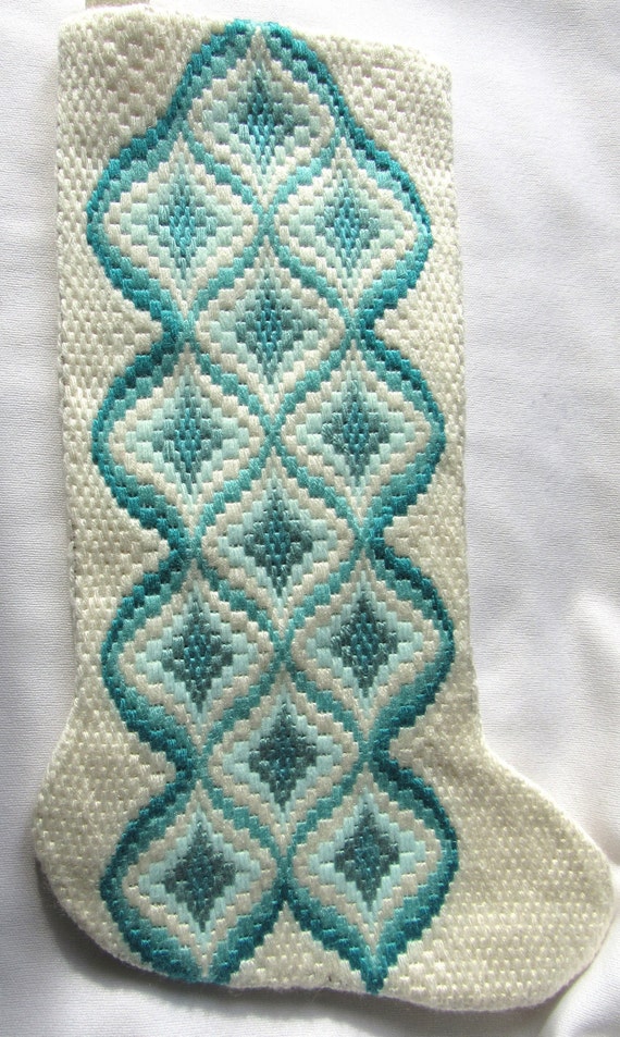 Christmas stocking needlepoint traditional bargello pattern done in teals and white The length is 15 12 and the width at top is 6 12.