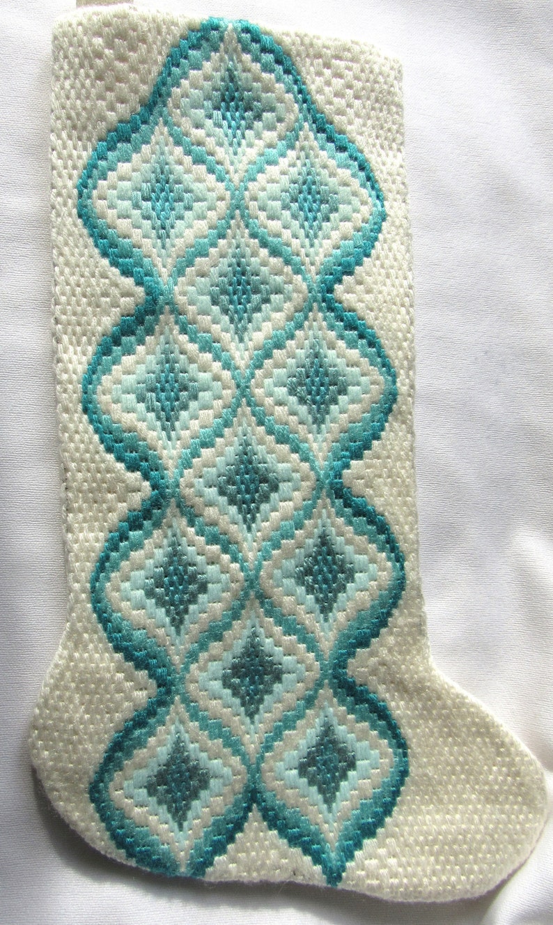 Christmas stocking needlepoint traditional bargello pattern done in teals and white The length is 15 12 and the width at top is 6 12.
