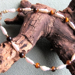 Bracelet long freshwater pearls, 4mm  round brown tigereye gemstones,  2mm 12k gold filled beads and  spring ring clasp.