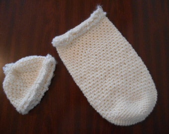 Baby cocoon with hat, hand crocheted of soft ecru baby yarn to keep baby warm and swaddled.
