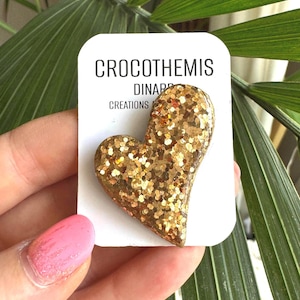 Asymmetrical gold glitter heart brooch