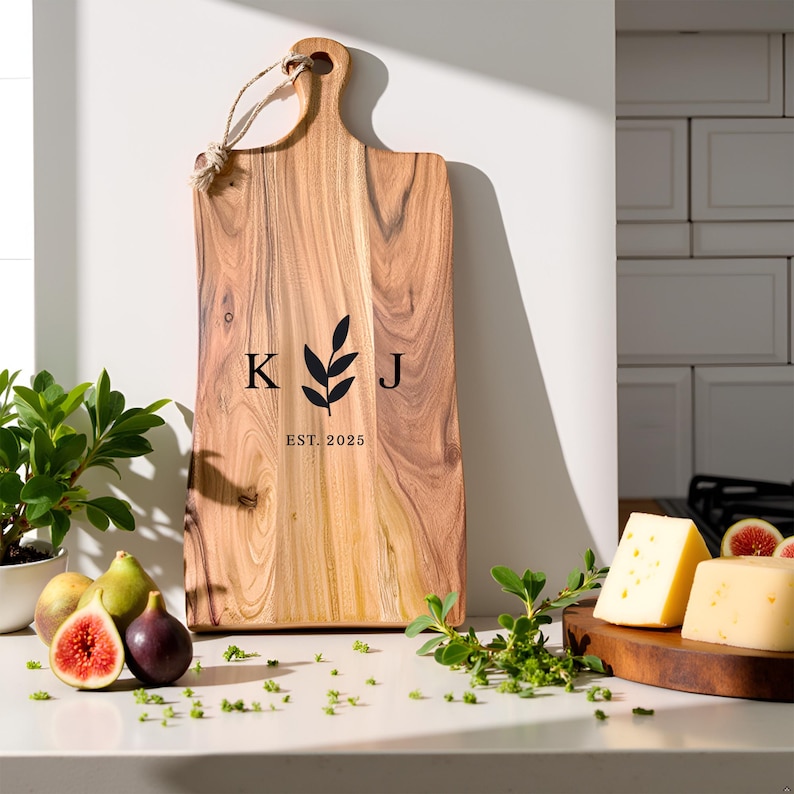 A Personalized cutting board with the initials of the couple and the date engraved, placed against a modern kitchen backdrop.