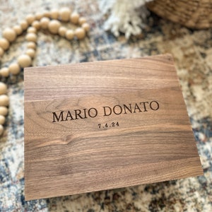 May include: A wooden box with the name "MARIO DONATO" and the date "7.4.24" engraved on the top.