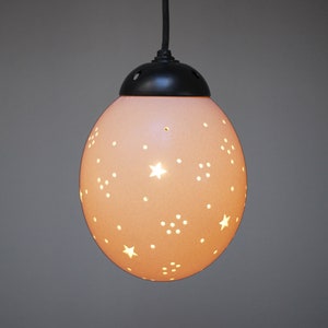 Moon and stars themed ostrich egg pendant: With delicate moons and stars handcarved by artisanal carvers into African ostrich eggshell