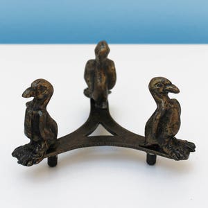 Penguin brass stand: these brass stands with full length penguins are designed to hold the carefully carved ostrich egg/tealight holders
