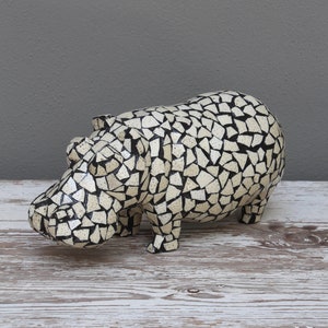 Mosaic eggshell hippo: One of the most feared of all African animals, the hippo is serenely captured in ostrich eggshell mosaic and wood